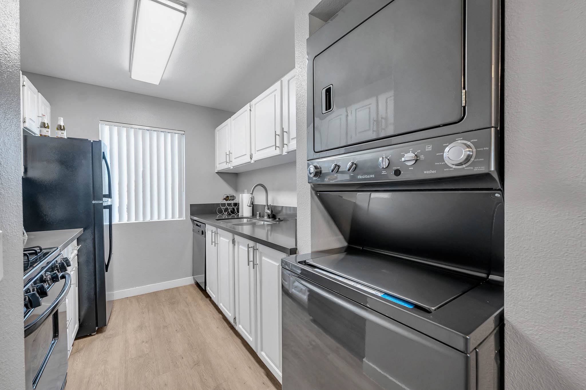 a kitchen with stainless steel appliances and white cabinets